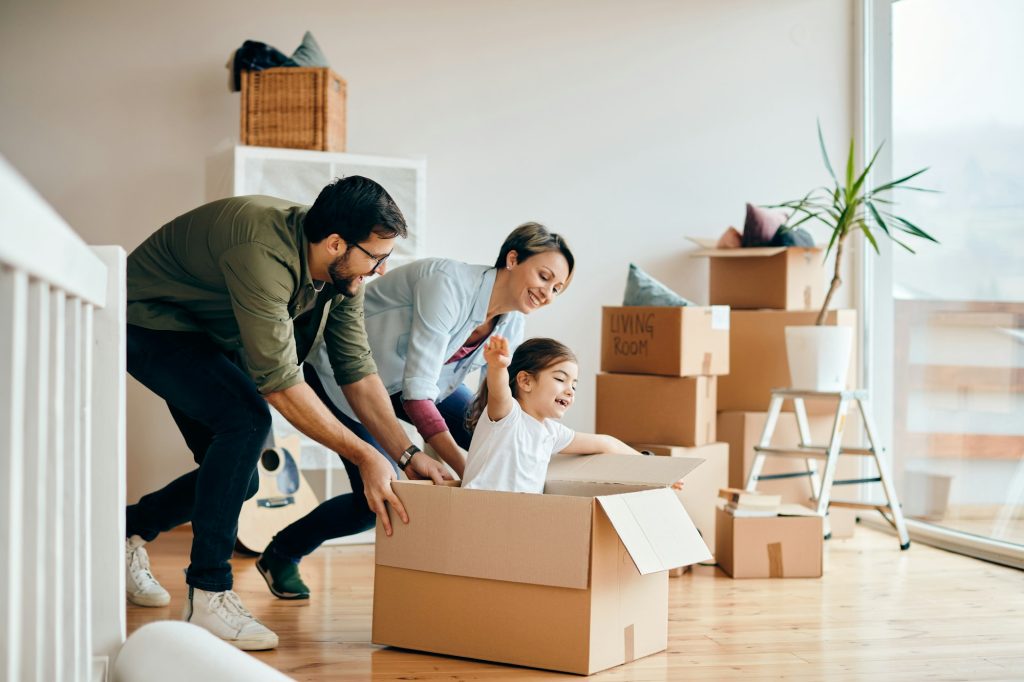 Playful family having fun while relocating in their new house.